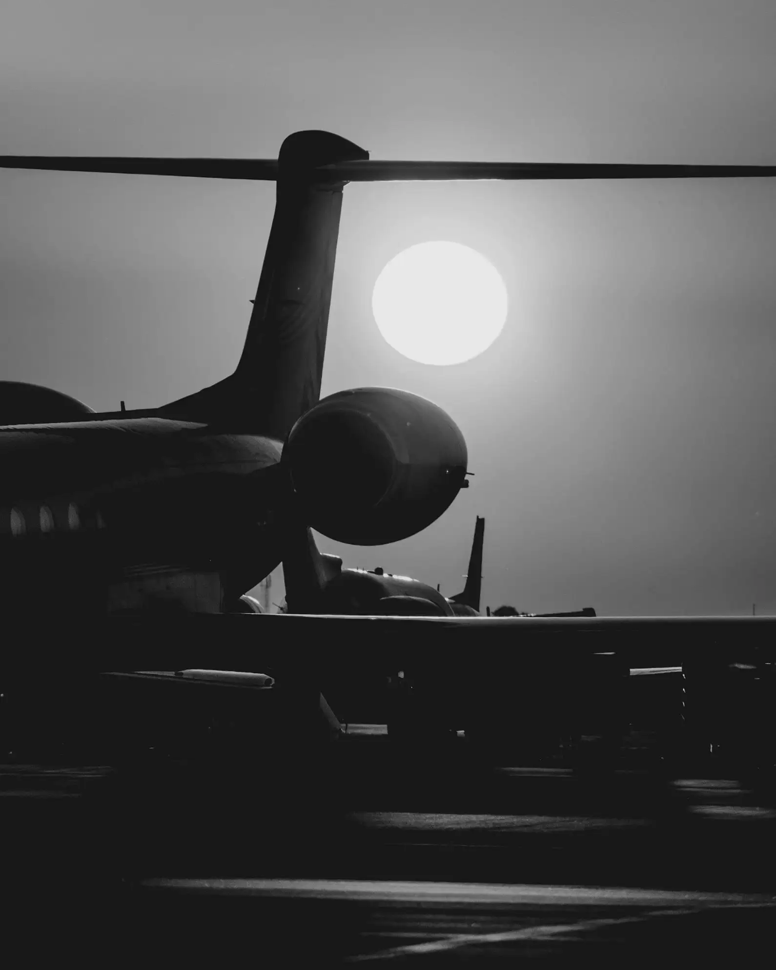 A business jet in silhouette against a low sun